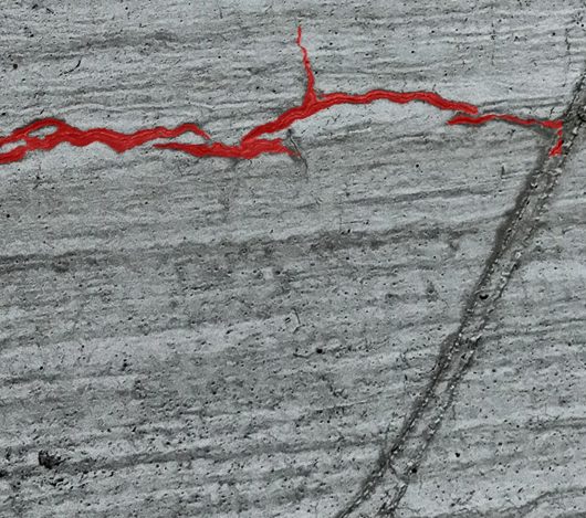 AI crack detection output with the fracture path traced on concrete