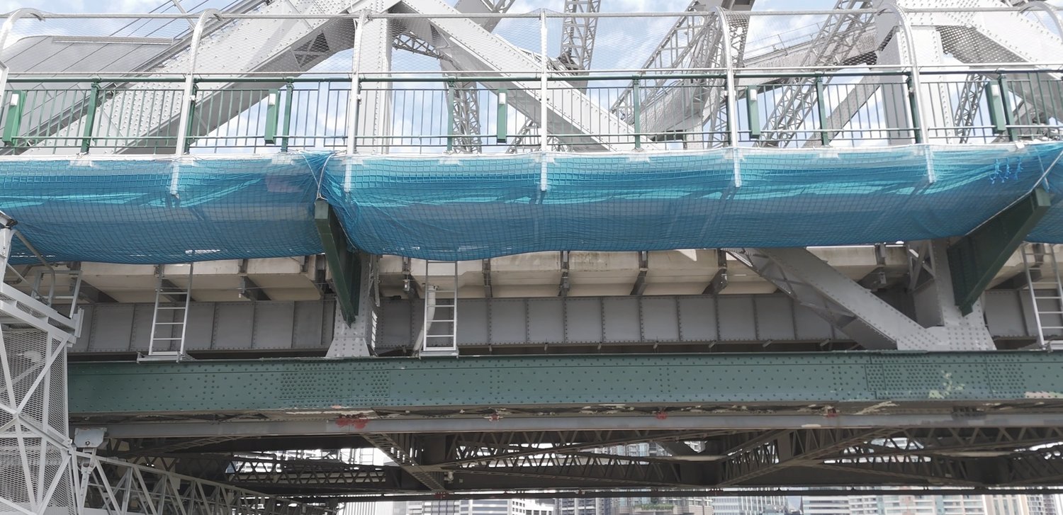 Under-deck view of the Story Bridge with containment netting during a drone inspection, Brisbane